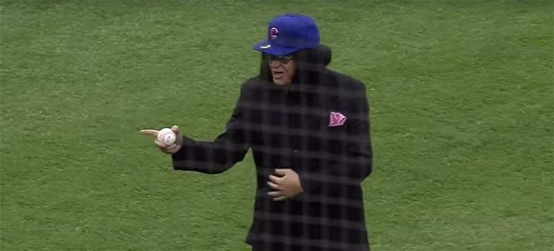 KISS bassist Gene Simmons sported a Chicago Cubs hat as he painted the corner of the plate with his opening pitch.