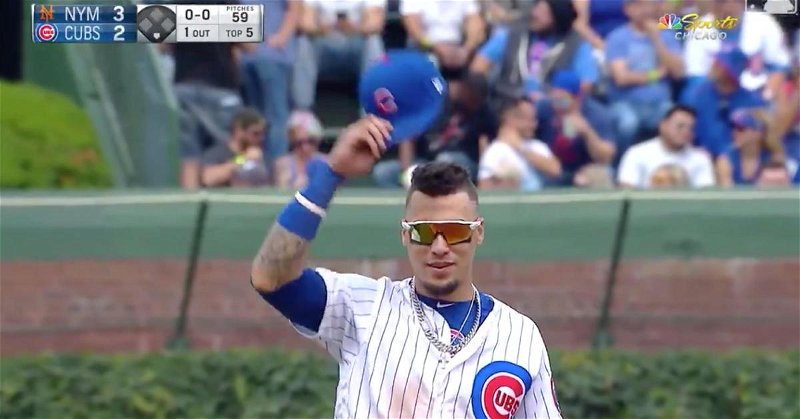 Javier Baez tipped his cap to the fans as if to playfully mock Adbert Alzolay.