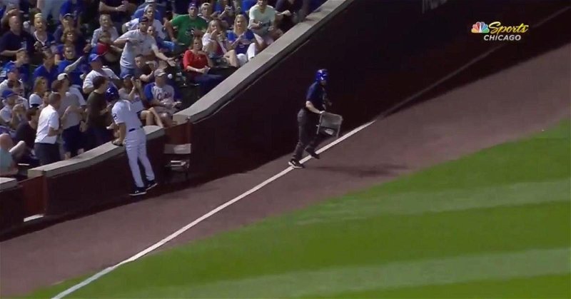 A distracted fan at Wrigley Field was lucky to avoid being drilled in the face by a bouncing foul ball.