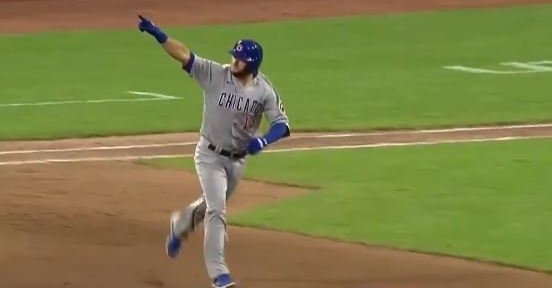 David Bote celebrates while he rounds the bases after his homer