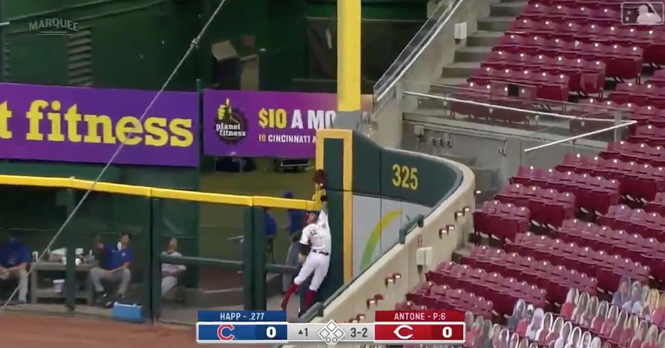 Former Cub Nicholas Castellanos made a futile attempt at catching Ian Happ's leadoff homer.