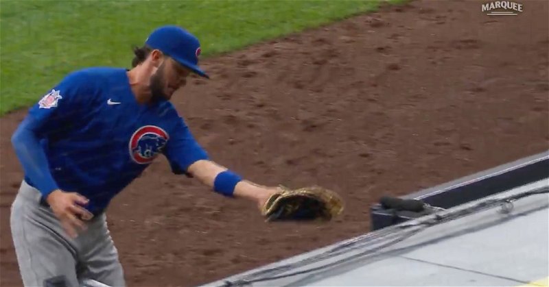 Kris Bryant was able to hang onto the ball when his momentum carried him down the dugout steps.