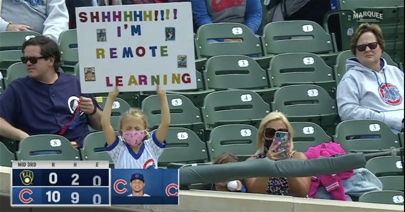 A little girl at Wrigley Field showed off her poster with an interesting interpretation of 