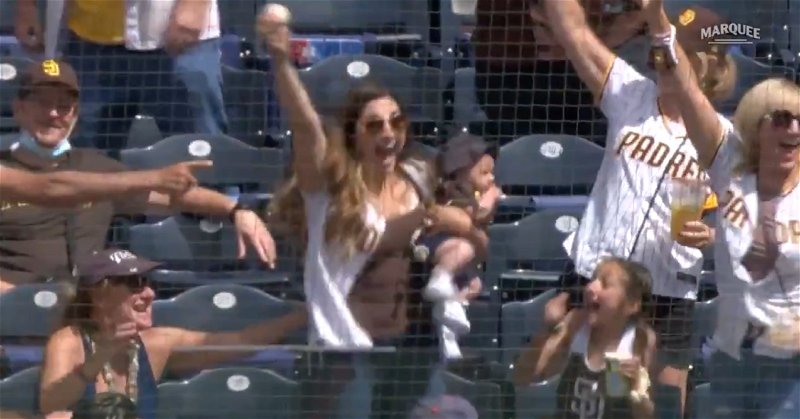 A multitasking mom in the stands at Petco Park caught a foul ball off a hop while holding her baby.