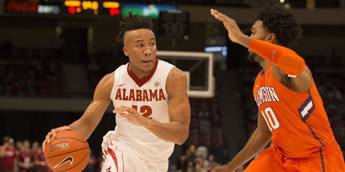 Crimson Tide guard Dazon Ingram (12) drives to the basket against Clemson Tigers guard Gabe DeVoe (10) at Legacy Arena.  <span style=