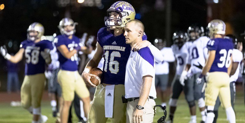 Pictured is one of the bright spots from Lawrence's outstanding season, where he posed with coach Joey King after breaking Deshaun Watson's career passing record. 